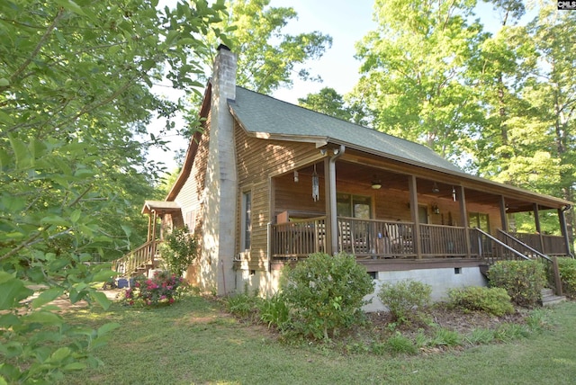 view of side of property with covered porch