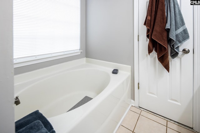 bathroom with tile patterned flooring and a bathing tub