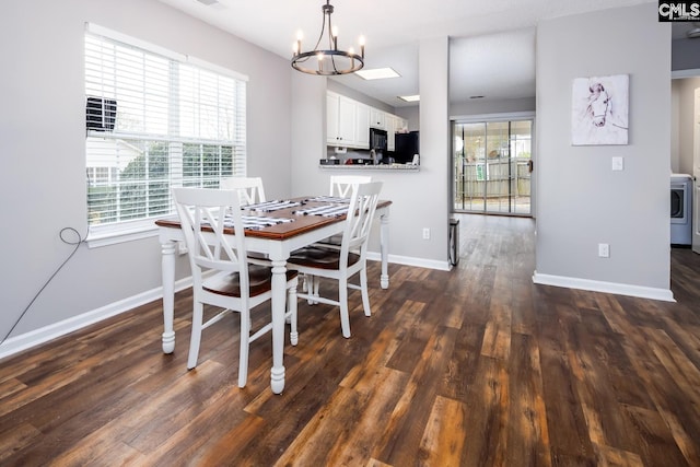 dining space featuring dark hardwood / wood-style flooring, an inviting chandelier, and a wealth of natural light