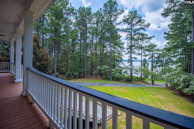 wooden terrace featuring a lawn