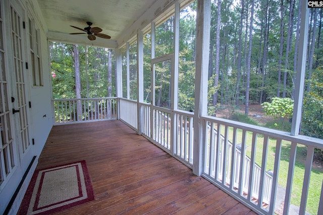 unfurnished sunroom with ceiling fan and a healthy amount of sunlight