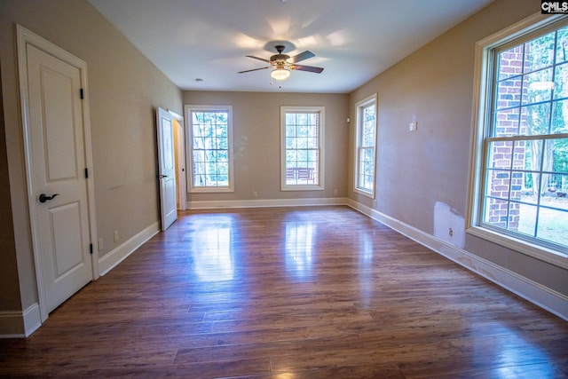 unfurnished room featuring ceiling fan and dark wood-type flooring