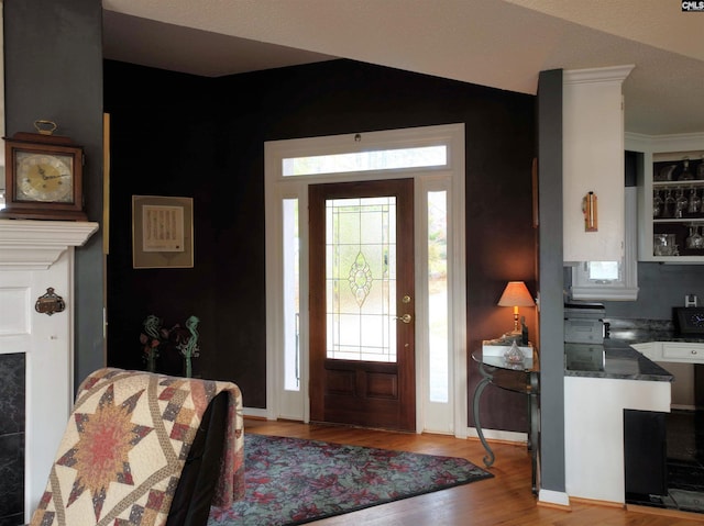 foyer featuring light hardwood / wood-style floors and lofted ceiling