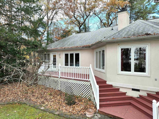 rear view of house with a wooden deck