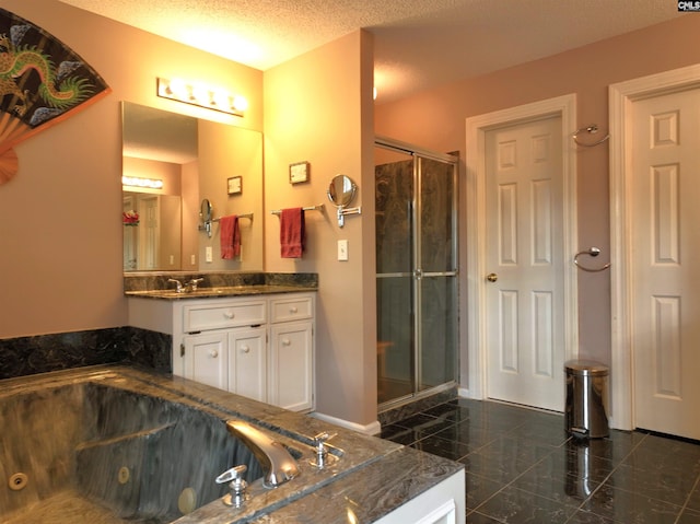 bathroom with plus walk in shower, vanity, and a textured ceiling