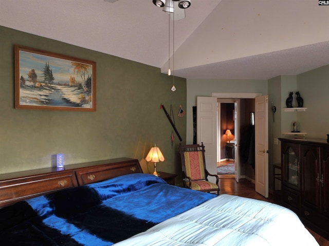 bedroom featuring dark hardwood / wood-style floors and lofted ceiling