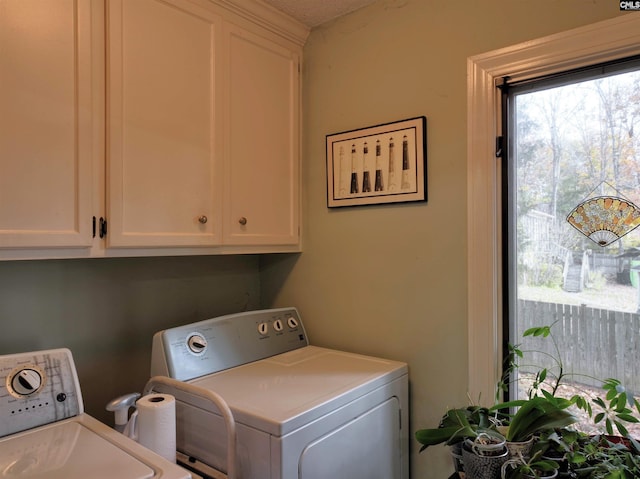 washroom featuring cabinets and washing machine and dryer