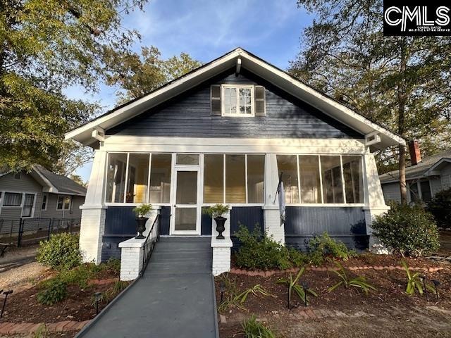 bungalow-style house featuring a sunroom