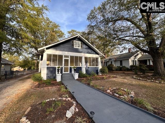 bungalow-style home with a sunroom