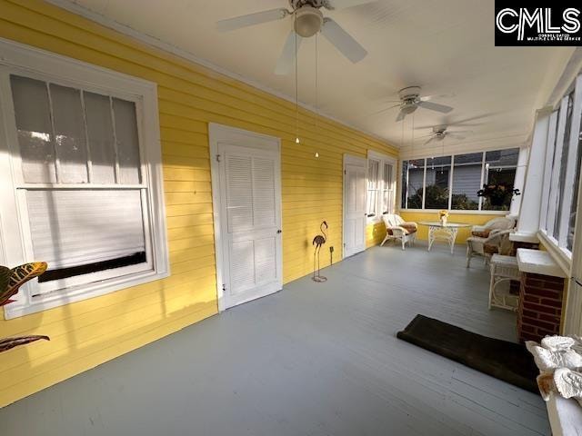 sunroom / solarium with ceiling fan