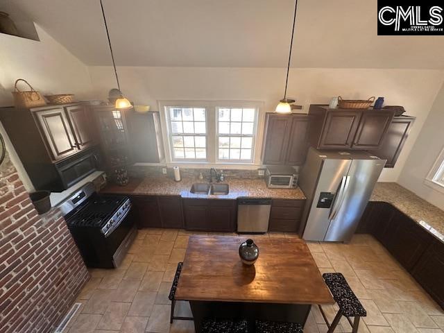 kitchen with sink, decorative light fixtures, dark brown cabinetry, and black appliances