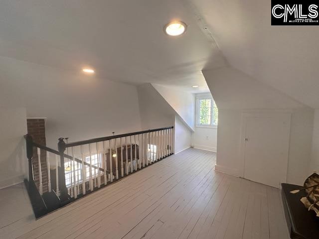 bonus room featuring hardwood / wood-style floors and vaulted ceiling