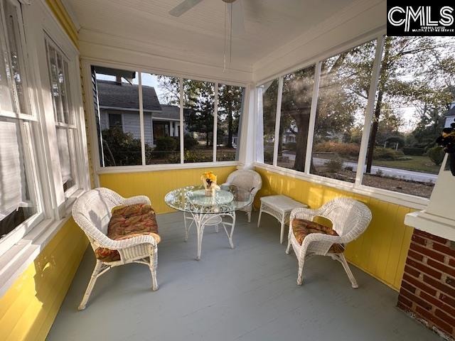 sunroom featuring plenty of natural light and ceiling fan