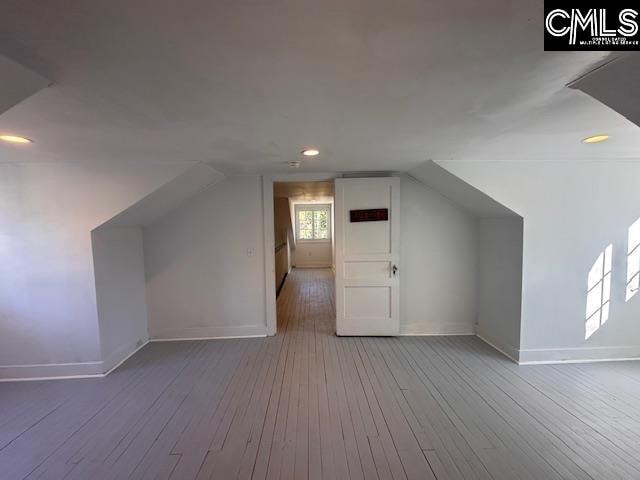 bonus room featuring hardwood / wood-style flooring and vaulted ceiling