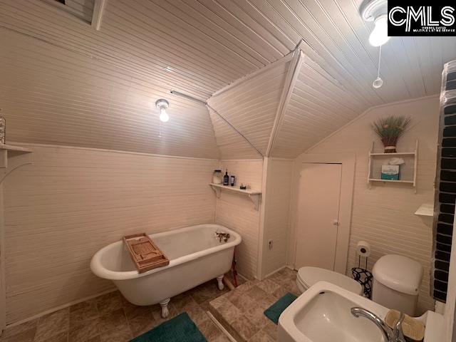 bathroom with a bath, wooden ceiling, lofted ceiling, and sink