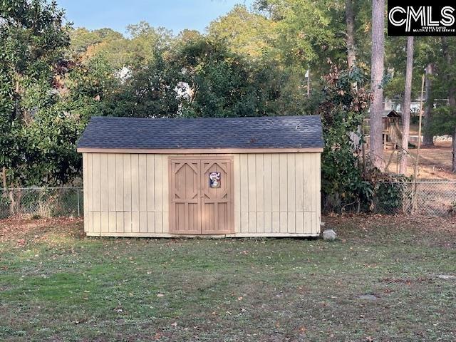 view of outbuilding with a lawn