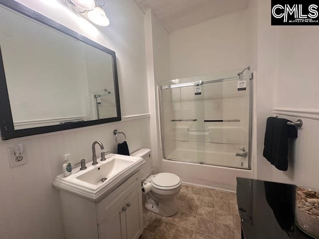 full bathroom with vanity, toilet, and enclosed tub / shower combo