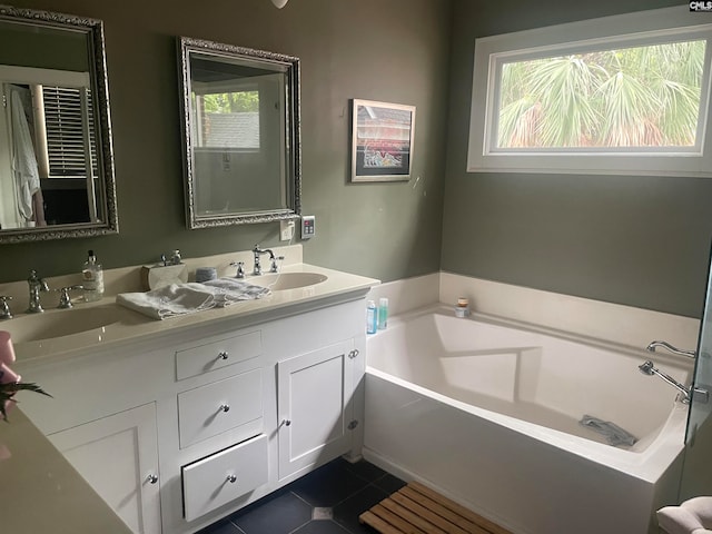 bathroom featuring a washtub, vanity, and tile patterned floors