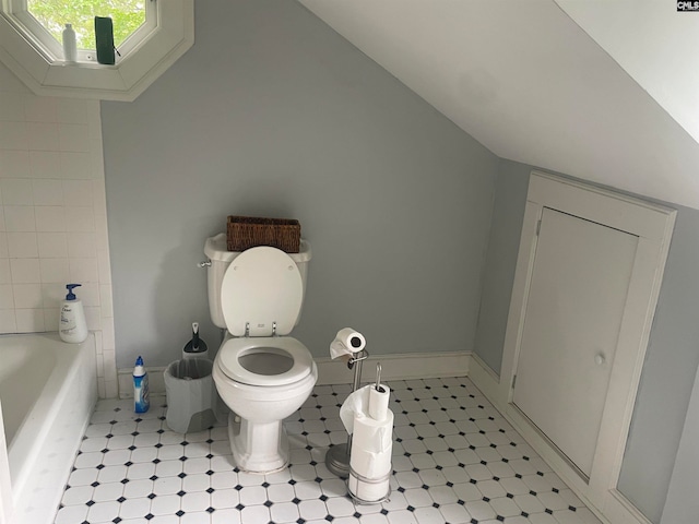 bathroom with toilet and a tub