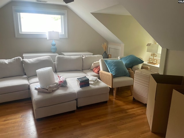 cinema room with hardwood / wood-style flooring and lofted ceiling