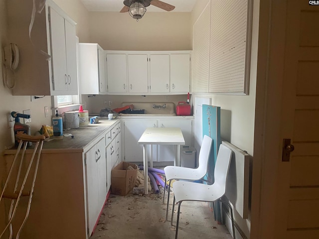 kitchen featuring white cabinets and ceiling fan