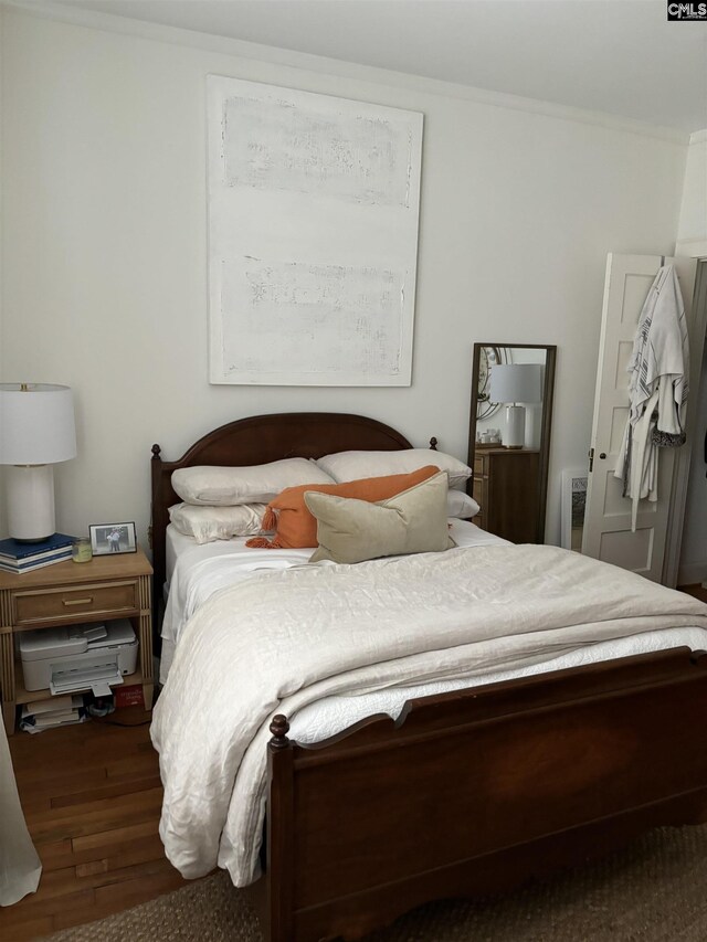 bedroom featuring crown molding and hardwood / wood-style floors