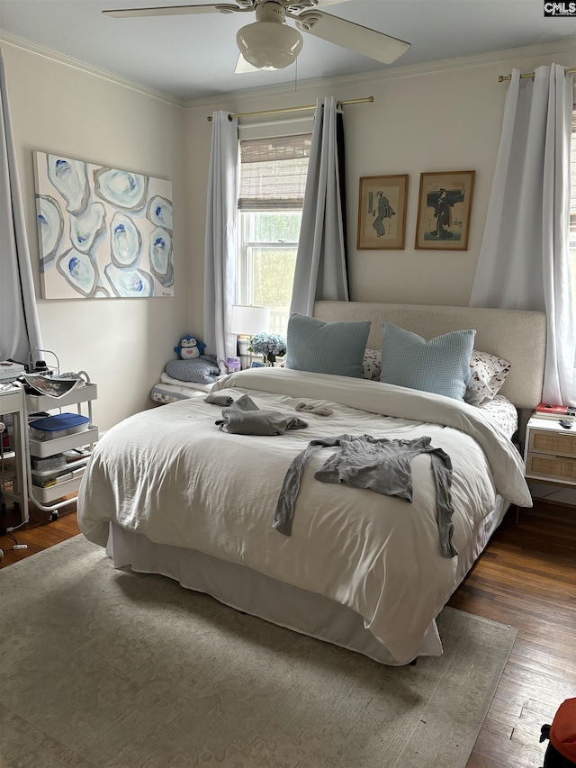 bedroom with ceiling fan, dark hardwood / wood-style floors, and ornamental molding