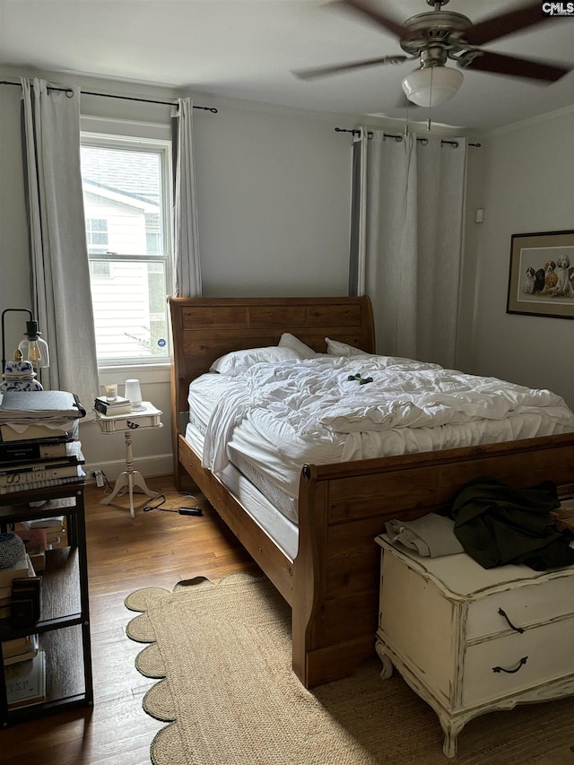 bedroom with light hardwood / wood-style flooring and ceiling fan