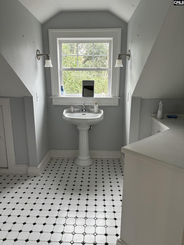 bathroom featuring vaulted ceiling