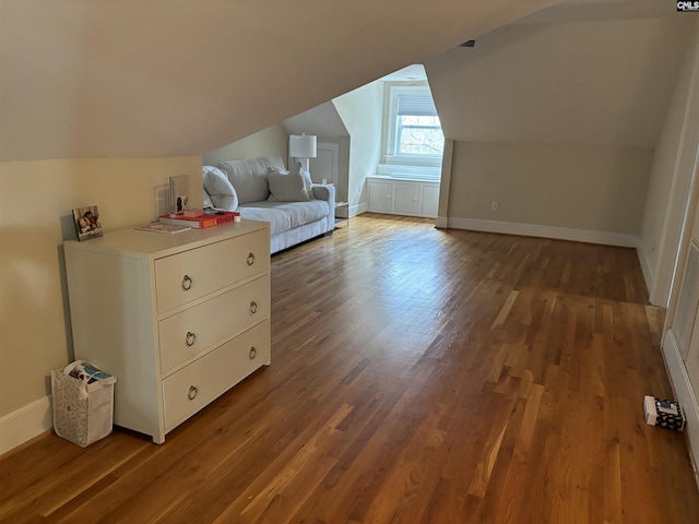 bonus room featuring dark hardwood / wood-style floors and vaulted ceiling