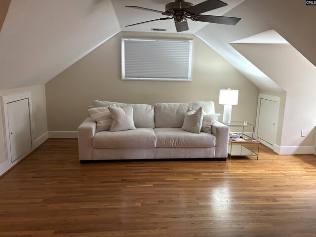 living room with ceiling fan, wood-type flooring, and lofted ceiling