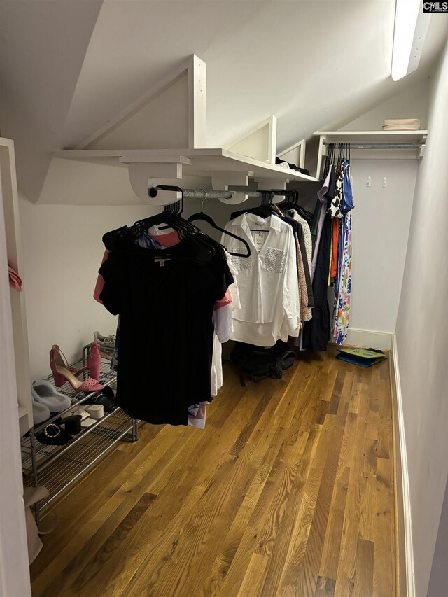 spacious closet featuring hardwood / wood-style floors and lofted ceiling