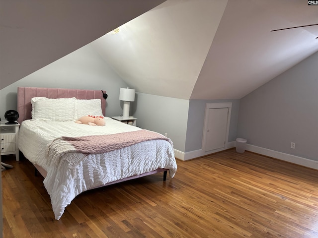 bedroom featuring hardwood / wood-style floors and vaulted ceiling