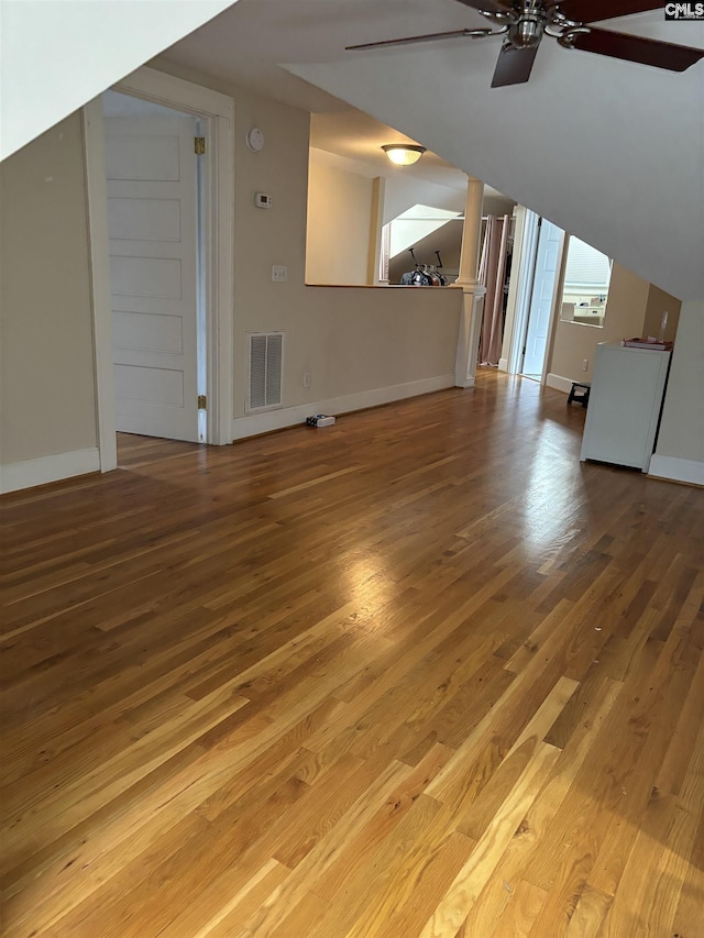 unfurnished living room with wood-type flooring, ceiling fan, and lofted ceiling