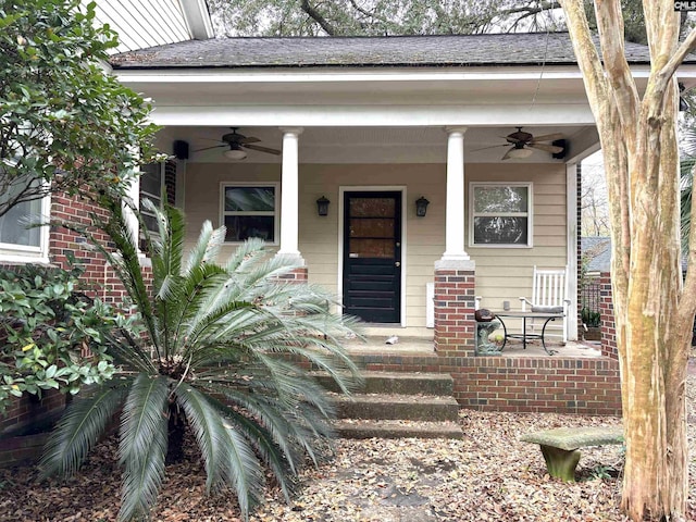 doorway to property featuring covered porch and ceiling fan