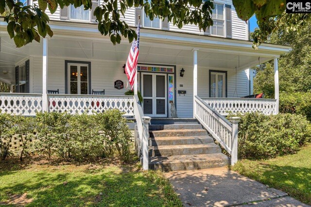 view of exterior entry with covered porch