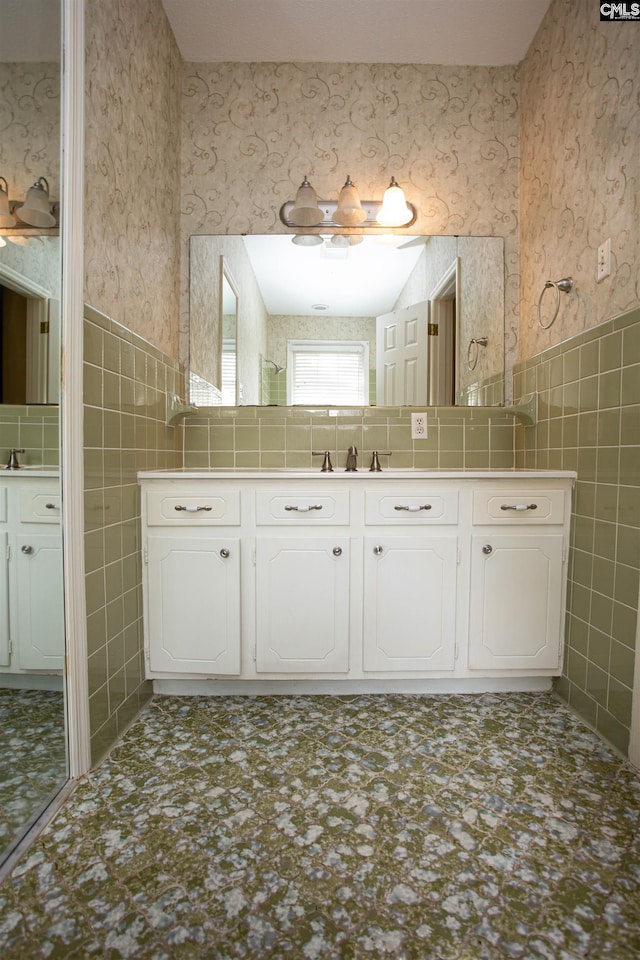 bathroom featuring vanity and tile walls