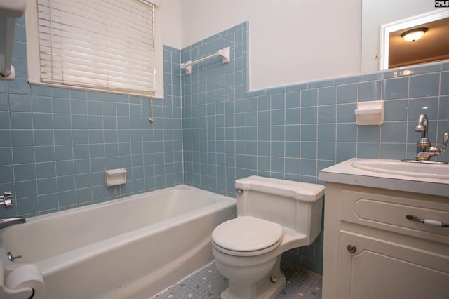 full bathroom with toilet, vanity, tile patterned floors, and tile walls