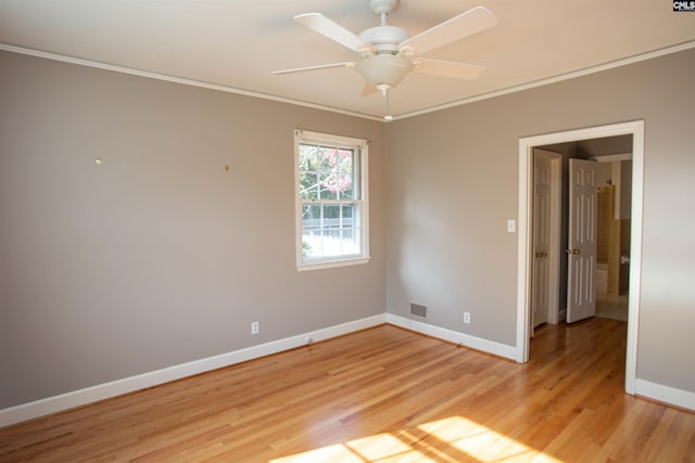 spare room featuring light hardwood / wood-style flooring, ceiling fan, and ornamental molding