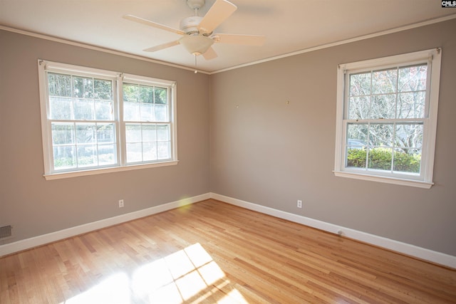 unfurnished room with light hardwood / wood-style flooring, plenty of natural light, ornamental molding, and ceiling fan