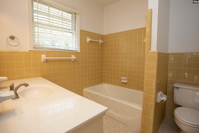 bathroom featuring tile patterned floors, a tub to relax in, toilet, and tile walls