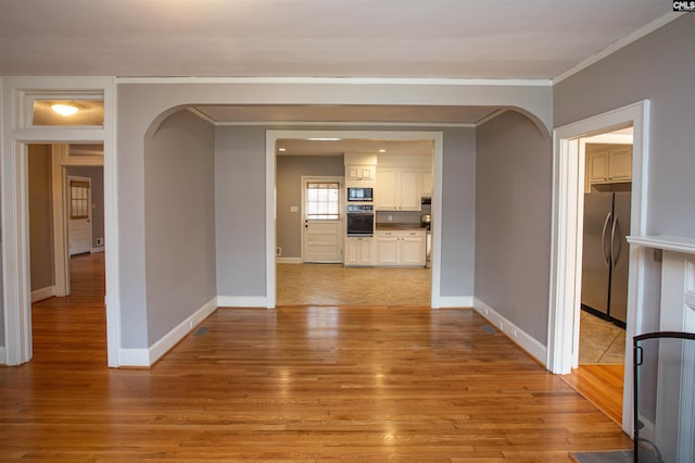 interior space featuring light hardwood / wood-style floors and ornamental molding