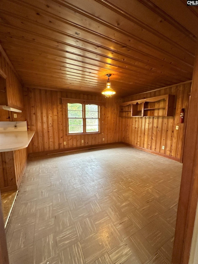 additional living space with wooden walls and wood ceiling