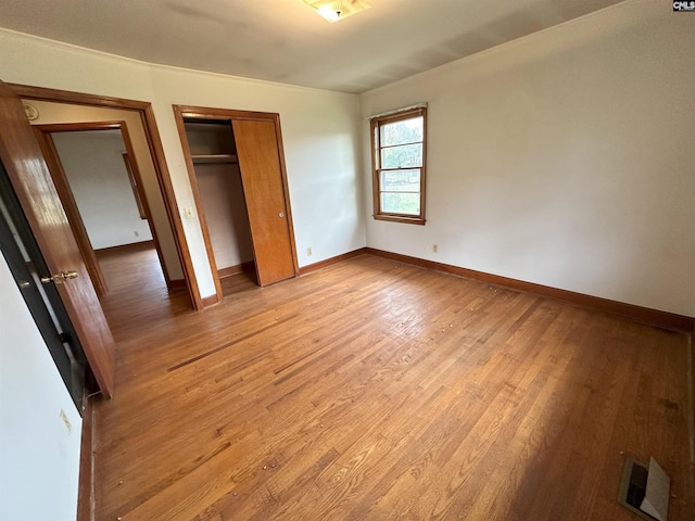 unfurnished bedroom with a closet and light hardwood / wood-style flooring