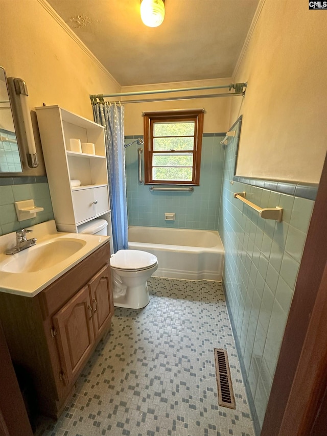 full bathroom with tile walls, vanity, shower / bath combo, and ornamental molding