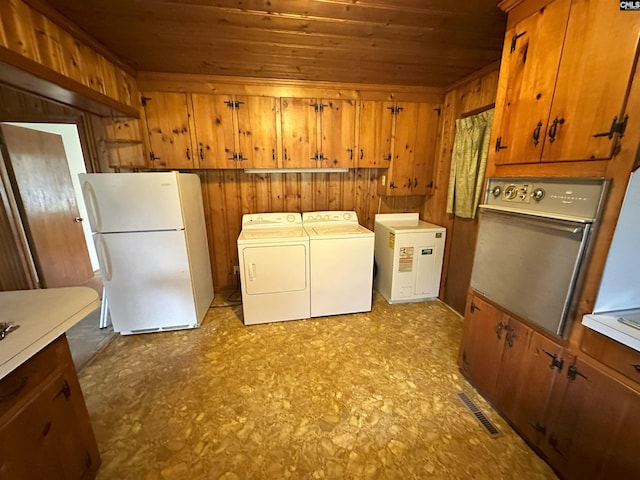 laundry area with wood walls, independent washer and dryer, and wooden ceiling