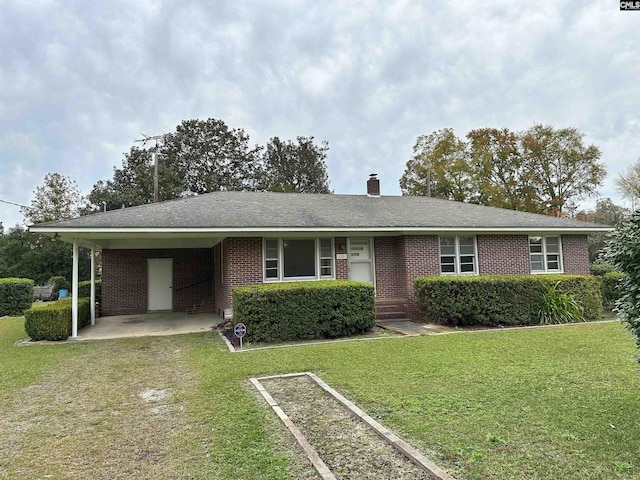 single story home with a front yard and a carport