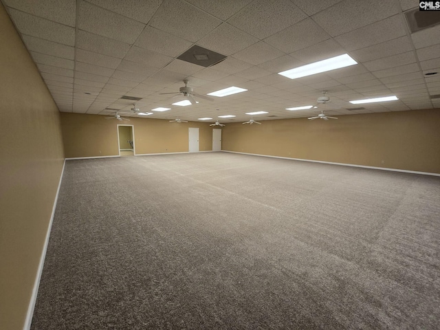 empty room with carpet flooring and a paneled ceiling