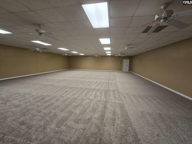 carpeted spare room with a paneled ceiling