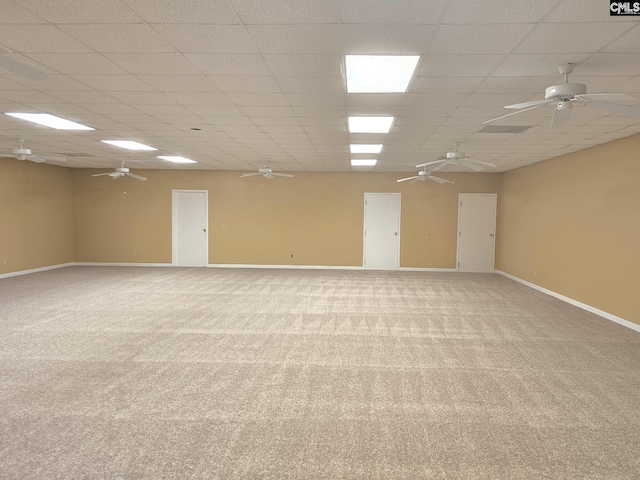 carpeted empty room with a paneled ceiling